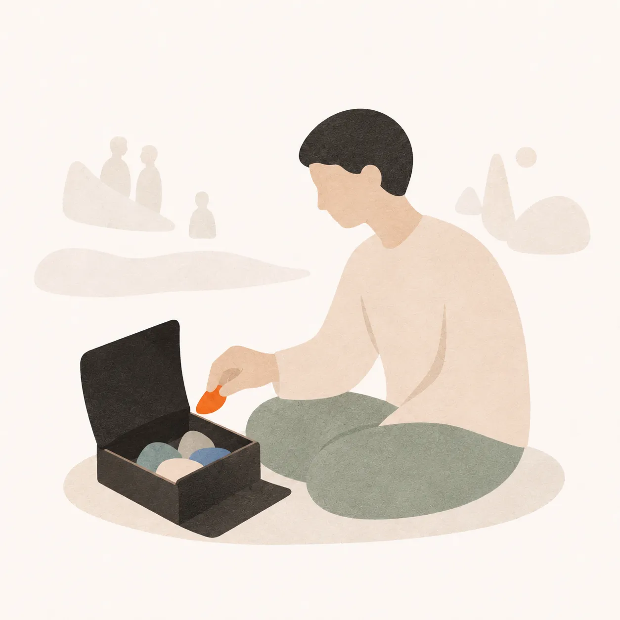 ひとりで、静かに箱へかけらをしまう人。まわりの人影は薄く描かれている